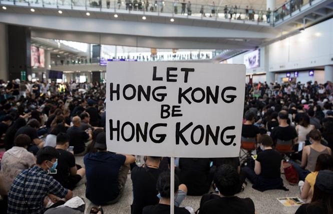 Protesters rally inside the arrivals hall of Hong Kong International Airport on August 9. Photo: Courtesy EPA-EFE