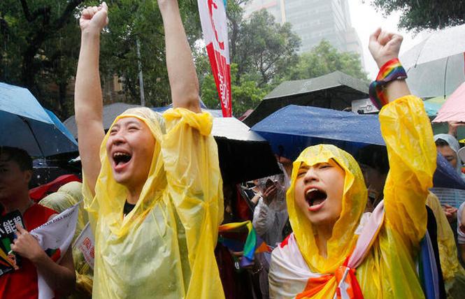 People celebrate the passage of a same-sex marriage bill May 17 outside of Taiwan's Legislative Yuan in Taipei. Photo: Courtesy AP