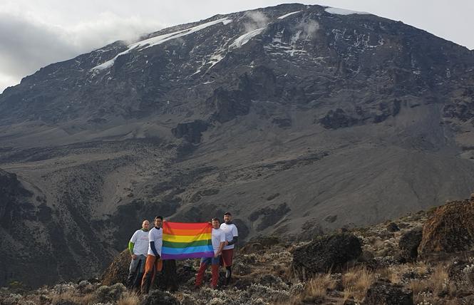 Gay activist and mountaineer Dastan "Danik" Kasmamytov, founder of Pink Summits, second from left, and his LGBT trekking group raised the rainbow flag at Mount Kilimanjaro's summit in 2019. Photo: Dastan "Danik" Kasmamytov/Pink Summits