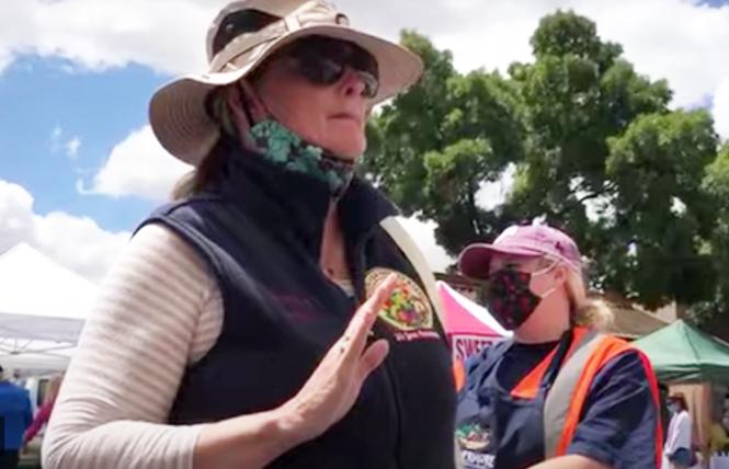 In a screenshot from a video taken June 7, California Farmers' Markets Association director Gail Hayden objects to a vendor passing out Pride flags. Photo: Courtesy Livermore Pride