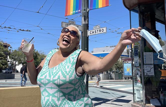 Veronika Fimbres, a transgender woman, celebrated the state's reopening Tuesday afternoon outside Twin Peaks Tavern in the Castro. Photo: Gooch