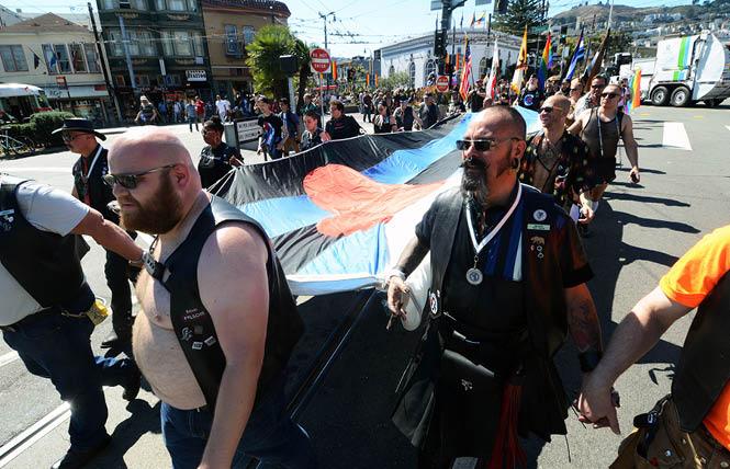 Participants carried a giant leather flag along Market Street for the 25th anniversary of LeatherWalk in September 2016. This year's event will see a new route for the walk. Photo: Rick Gerharter