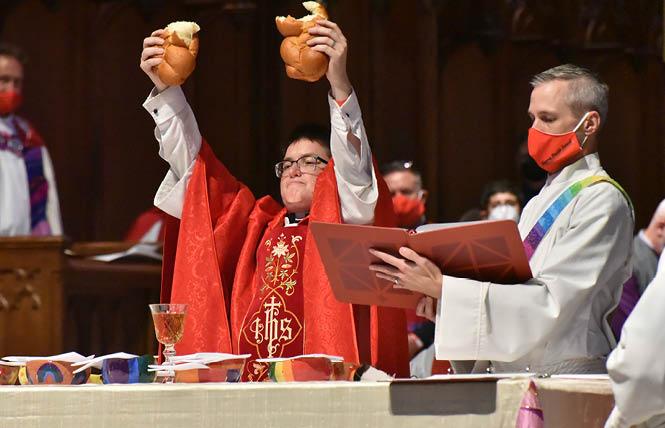 Evangelical Lutheran Church in America Bishop Megan Rohrer breaks bread for Communion during their installation ceremony September 11 at Grace Cathedral in San Francisco. Photo: Gooch