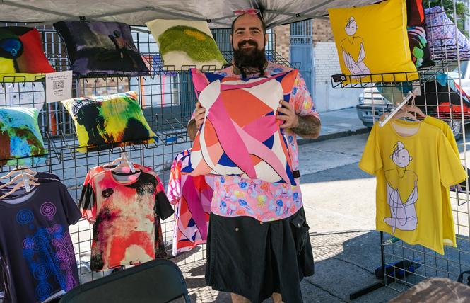 Vendor Alexander Prestia shows off some of his pillows and T-shirts for sale at the July 10 SOMA Second Saturdays event. Photo: Brandon Roberts