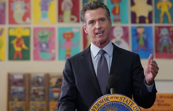 Governor Gavin Newsom signed a bill to allow for trans and nonbinary college students to use their lived names on diplomas and academic records. Photo: Courtesy AP