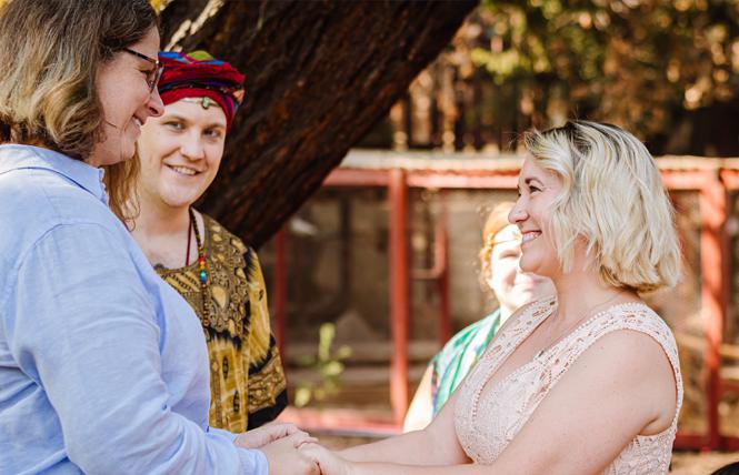 Isis Oasis Sanctuary High Priestess and Executive Director deTraci Regula, background, looked on as the Reverend Justin Howard, center, officiated Livermore Pride founders Tracy Kronzak, left, and Amy Rose's, right, wedding ceremony last year at the Geyserville sanctuary. Photo: Brittni Kiick Photography
