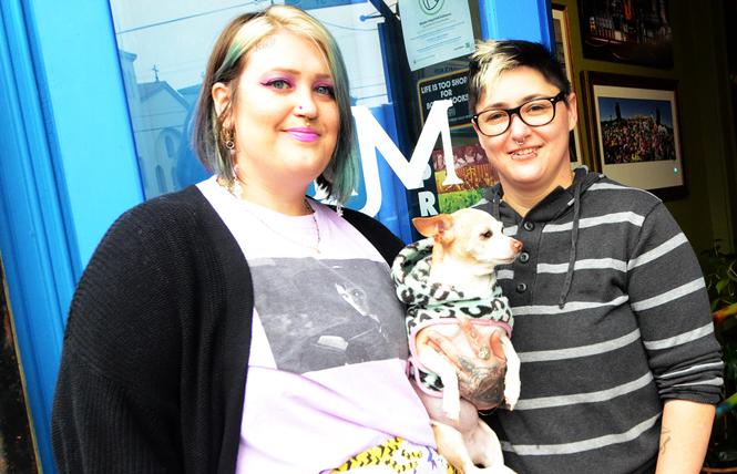 Fiancees Katey "Scoots" McKee, left, and Sharon Ratton, with their dog, Wednesday, stand outside at the entrance to their cafe, Milk SF. Photo: Rick Gerharter