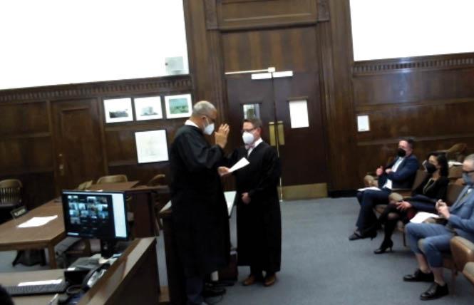 Alameda County Superior Court Presiding Judge Charles Smiley, left, administers the oath of office to new Judge Peter E. Borkon during a virtual swearing in ceremony February 24. Photo: Screengrab