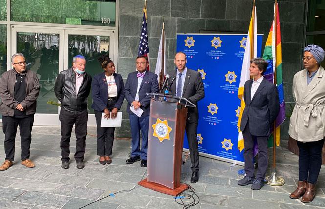 San Francisco District Attorney Chesa Boudin, at microphone, announces changes to the office's policies on pronouns in June 2021. Photo: John Ferrannini