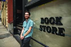 MJ Halberstadt in front of the old Calamus Books site. Photo credit Nile Scott Studios