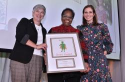 Boston School Committee Chair Jeri Robinson, center, holds her Shero Award presented by Kristin McSwain (left), senior advisor and director of Mayor Michelle Wu's Office of Early Childcare, and Ellis Early Learning CEO Lauren Cook during the nonprofit's annual benefit event on Thursday, Oct. 27, 2022. (Photo by Craig Bailey/Perspective Photo)