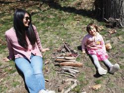 South Ender Selah Thissell, 4, shows off her creation with her mom, Youngshin Thissell, at the Fairy House Building Workshop hosted by the Boston Parks and Recreation Department and the Mayor's Mural Crew at Franklin Park's Schoolmaster Hill on April 20. Children were encouraged to connect with their natural surroundings by creating their own personalized, eco-friendly homes for the woodland fairies of Franklin Park and to wear their favorite fairy and elf costumes. Photo by Jon Seamans.