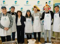Boston City Council President Ed Flynn, Boston City Councilor for District 3 John FitzGerald, Pine Street President and Executive Director Lyndia Downie, Boston Mayor Michelle Wu, Boston Bruins Kevin Shattenkirk and Charlie McAvoy at Pine Street Inn on Thanksgiving Day 2023. Photo by John Rich Photography.