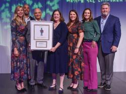 Natixis Investment Managers U.S. President & CEO David Giunta (holding frame) accepts the "Champion of Early Childhood Education" award at Ellis Early Learning's "Celebrating Ellis and the Magic of Childhood" benefit event.Giunta is joined by (from left) Laima Bobelis,  Jerome Smith, Coleen Dinneen, Molly Gorman, Lauren Cook, and Sean Curran. Photo by Craig Bailey, Perspective Photo.